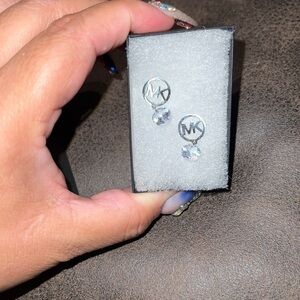 MK‎ earrings with dangling diamond shape stone